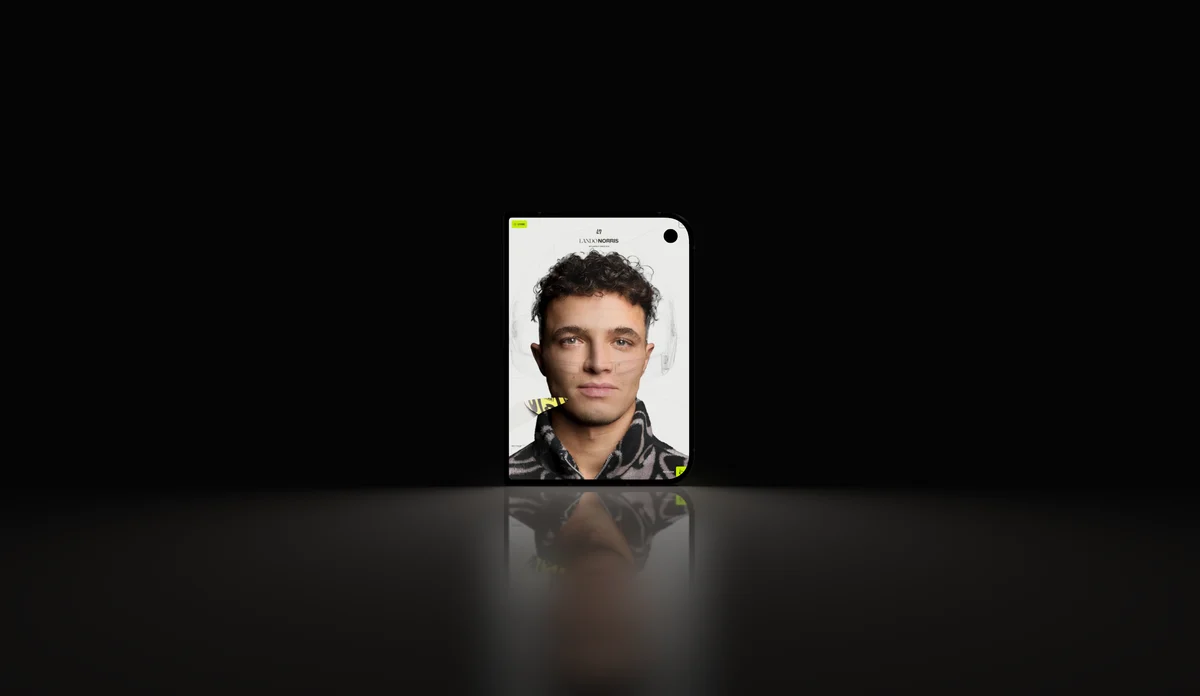 A folding phone in a narrow beam of light on a dark floor, a portrait on its screen.