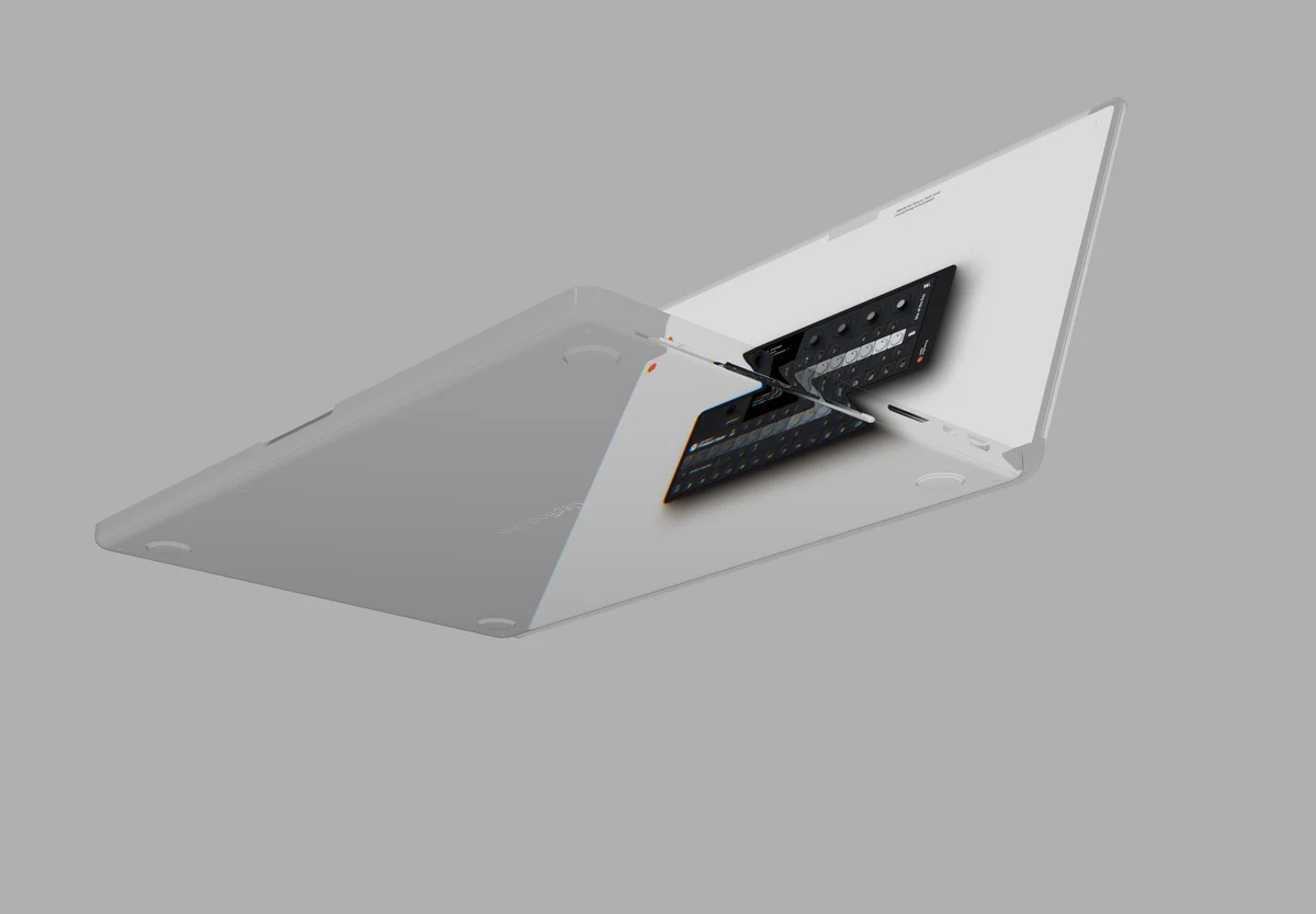 A pale grey laptop seen from below at a steep angle, its screen tipped towards a grey sky.