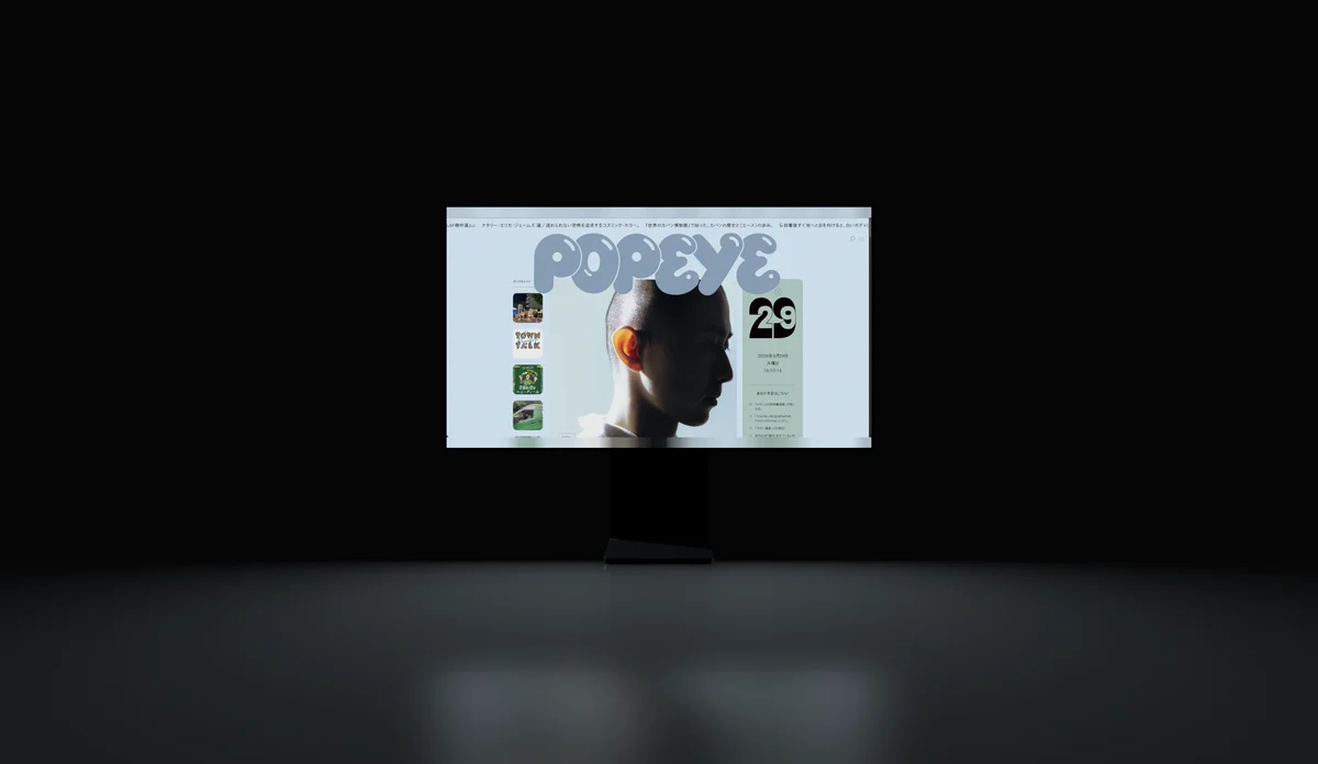 A monitor on a dark glossy floor, its screen reflected beneath it.