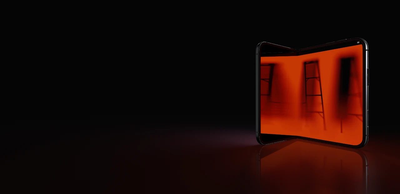 The Fold, half open, lit in orange on a dark reflective floor.